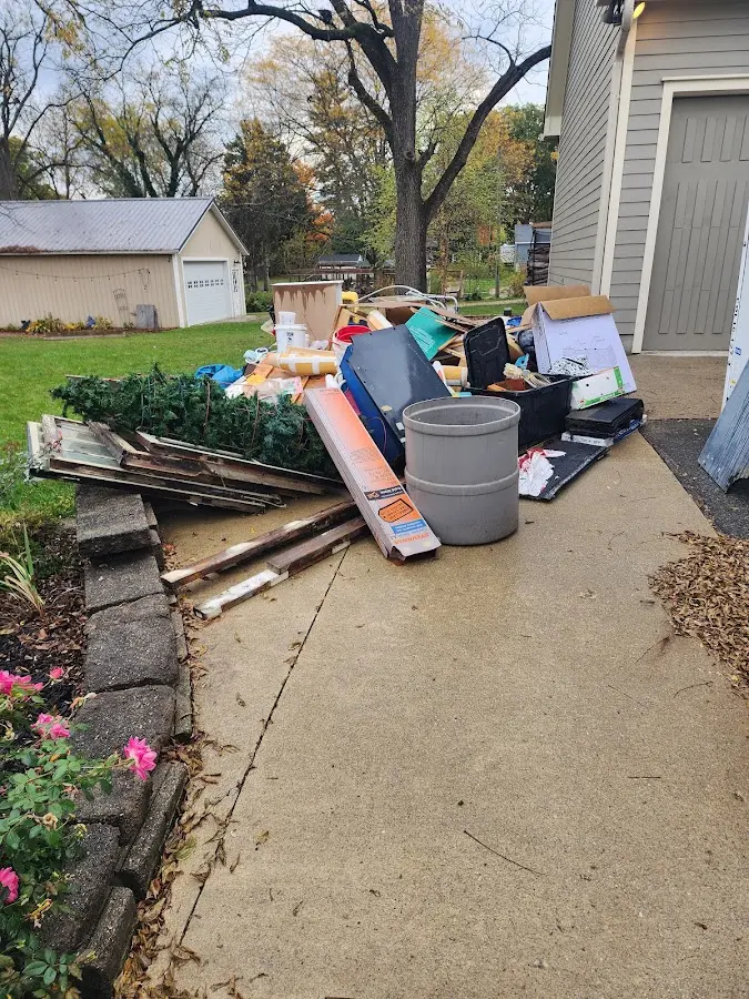 Dumpster being loaded with debris for Estate Cleanout Dumpster Rental in Morton